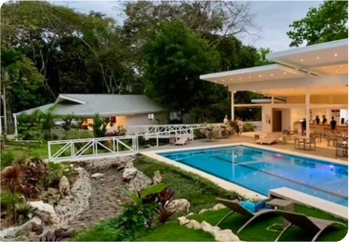 A poolside terrace at the hotel, surrounded by trees